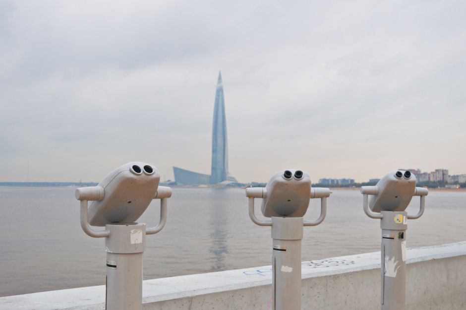 Scenic view of telescopes overlooking the water and skyscraper in Saint Petersburg.